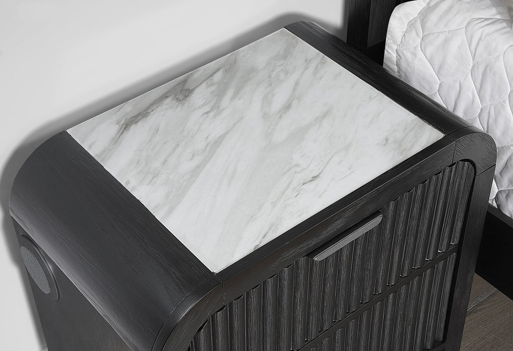 Beckett nightstand close-up showing the white marble-look top and side speaker