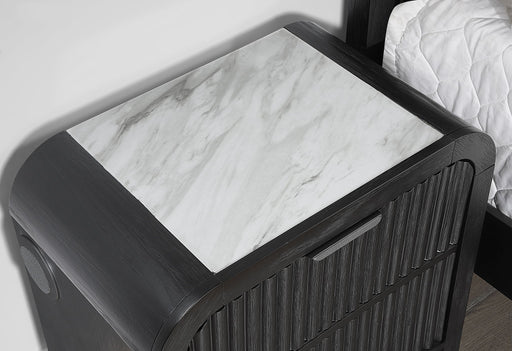 Beckett nightstand close-up showing the white marble-look top and side speaker