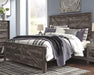 Wynnlow King Crossbuck Panel Bed with Mirrored Dresser, Chest and Nightstand - alternate view 13